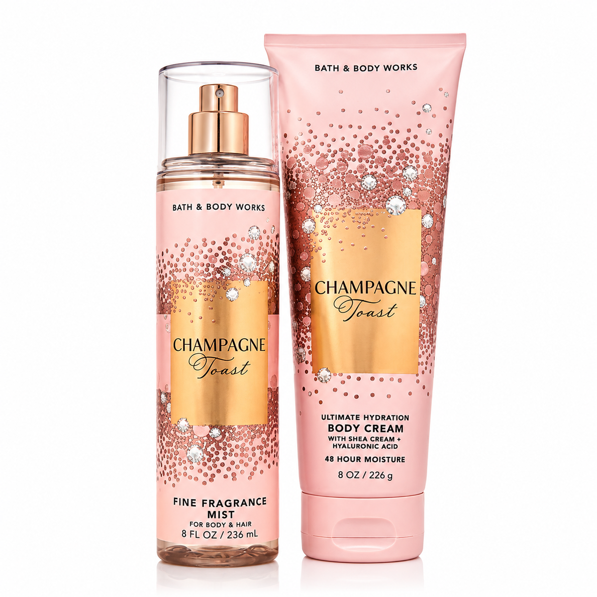 Bath & Body Works Champagne Toast set con body mist 236ml en frasco transparente rosa con detalles dorados y brillantes y crema corporal 226g en tubo rosa con diseño de burbujas doradas y cristales, fondo blanco